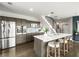 Modern kitchen with an island, barstool seating, wood floors, and stainless steel appliances at 132 Mirror Lake N Dr # 501, St Petersburg, FL 33701