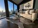 Modern living room featuring a large window with stunning city views, contemporary art, and stylish decor at 132 Mirror Lake N Dr # 501, St Petersburg, FL 33701