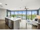 Open floorplan with kitchen island and living room with lake view and floor-to-ceiling windows at 132 Mirror Lake N Dr # 501, St Petersburg, FL 33701