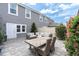 Spacious backyard patio features comfortable seating, a dining table, and beautiful plants, ideal for outdoor living and entertaining at 13306 Wildgrass Trl, Odessa, FL 33556