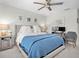 Bedroom features a ceiling fan, bright natural light, and cozy décor at 13306 Wildgrass Trl, Odessa, FL 33556