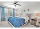 Bedroom features a ceiling fan and bright natural light at 13306 Wildgrass Trl, Odessa, FL 33556
