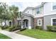 Charming home with stone accents, green shutters, and a landscaped front yard at 13306 Wildgrass Trl, Odessa, FL 33556