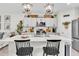 Bright kitchen with stainless steel appliances, a kitchen island, and modern lighting at 13306 Wildgrass Trl, Odessa, FL 33556