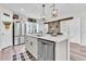 Modern kitchen features an island, stainless appliances, and a view into the dining area at 13306 Wildgrass Trl, Odessa, FL 33556