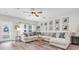Spacious living room featuring stylish decor, a large sectional, and plenty of natural light at 13306 Wildgrass Trl, Odessa, FL 33556