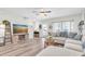 Bright living room with a ceiling fan, modern furnishings, and a large sectional sofa at 13306 Wildgrass Trl, Odessa, FL 33556