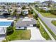 Aerial view of home with a well-maintained lawn and proximity to the beach and nearby canals at 13715 Maria Dr, Hudson, FL 34667