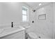 Modern bathroom featuring a shower with stylish tiling, a new toilet, sink vanity and window at 13715 Maria Dr, Hudson, FL 34667