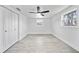 Clean bedroom with two windows and a ceiling fan providing ample natural light and air circulation at 13715 Maria Dr, Hudson, FL 34667