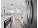 Contemporary kitchen with stainless steel appliances, white cabinetry and a large island for cooking and dining at 13715 Maria Dr, Hudson, FL 34667
