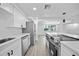 Bright kitchen boasts stainless steel appliances, sleek countertops, and plenty of cabinet space at 13715 Maria Dr, Hudson, FL 34667