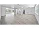 Bright open-concept space with neutral walls, recessed lighting, and seamless flow to kitchen and living areas at 13715 Maria Dr, Hudson, FL 34667