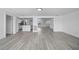 Bright open-concept space with neutral walls, recessed lighting, and seamless flow to kitchen and living areas at 13715 Maria Dr, Hudson, FL 34667