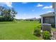 Expansive backyard featuring lush green grass, a neighboring fence and ample space at 13919 Wineberry Dr, Dade City, FL 33525