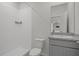 Modern bathroom featuring a shower and vanity with granite countertop at 13919 Wineberry Dr, Dade City, FL 33525