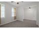 Bedroom featuring tile flooring, natural light, and a ceiling fan with views of adjacent room at 13919 Wineberry Dr, Dade City, FL 33525