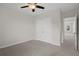 Bedroom with ceiling fan, closet, carpet, and nearby entrance at 13919 Wineberry Dr, Dade City, FL 33525