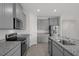 Well-equipped kitchen featuring gray cabinets, granite countertops, and stainless appliances at 13919 Wineberry Dr, Dade City, FL 33525