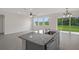 Modern kitchen island with granite countertops and stainless steel sink at 13919 Wineberry Dr, Dade City, FL 33525