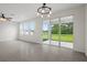Bright living room with backyard view through sliding glass doors at 13919 Wineberry Dr, Dade City, FL 33525