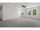 Spacious main bedroom with carpet, ceiling fan, recessed lighting and natural light from windows at 13919 Wineberry Dr, Dade City, FL 33525