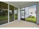 Sliding glass doors lead to the screened-in porch with views of the yard and surrounding landscape at 13919 Wineberry Dr, Dade City, FL 33525