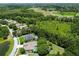 Aerial view of community surrounded by lush greenery and lakes, offering a serene environment at 1460 Kensington Woods Dr, Lutz, FL 33549