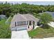Aerial view showcasing the home's attractive exterior, three-car garage, landscaping, and desirable neighborhood at 1460 Kensington Woods Dr, Lutz, FL 33549
