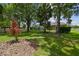 Serene backyard with mature trees, colorful landscaping, and screened-in lanai, ideal for outdoor entertaining at 1460 Kensington Woods Dr, Lutz, FL 33549