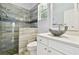 A stylish bathroom features a walk-in shower with tiled walls and a modern vessel sink at 1460 Kensington Woods Dr, Lutz, FL 33549