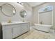 This bathroom offers a dual vanity, soaking tub, and a bright window at 1460 Kensington Woods Dr, Lutz, FL 33549