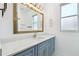 Bathroom vanity featuring custom cabinets, gold accents, and modern lighting at 1460 Kensington Woods Dr, Lutz, FL 33549