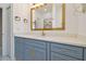 Bathroom vanity features a stylish gold faucet, sleek hardware, white countertop, and modern mirror at 1460 Kensington Woods Dr, Lutz, FL 33549