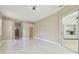 This bedroom features sleek, tile floors, recessed lighting, and a glass door to the Primary bathroom at 1460 Kensington Woods Dr, Lutz, FL 33549