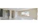 Bright bedroom with large window, closet, and modern marble tile flooring at 1460 Kensington Woods Dr, Lutz, FL 33549