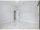 Bright and airy bedroom with elegant marble floors and an open doorway at 1460 Kensington Woods Dr, Lutz, FL 33549