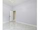 Bright, spacious bedroom featuring light-colored walls and elegant marble floors at 1460 Kensington Woods Dr, Lutz, FL 33549