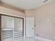 Bedroom with a large closet, shelving and marble tile flooring at 1460 Kensington Woods Dr, Lutz, FL 33549