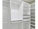 The walk-in closet has custom storage solutions, including shelving and drawers for optimal organization at 1460 Kensington Woods Dr, Lutz, FL 33549