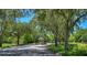 Picturesque community entrance with mature trees, a gated entry and a gazebo, creating a serene ambiance at 1460 Kensington Woods Dr, Lutz, FL 33549