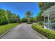 Gated community entrance with manicured landscaping and mature trees, offering an inviting appeal at 1460 Kensington Woods Dr, Lutz, FL 33549