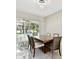 Elegant dining room with chandelier, marble floors, and sliding glass doors leading to outdoor pool area at 1460 Kensington Woods Dr, Lutz, FL 33549