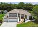 Charming two-story home featuring a manicured lawn, beautiful landscaping, and a two-car garage at 1460 Kensington Woods Dr, Lutz, FL 33549