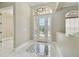 Bright foyer featuring marble floors with inlay, and a decorative glass front door with sidelights at 1460 Kensington Woods Dr, Lutz, FL 33549