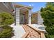 Inviting home entrance with brick pathway, manicured landscaping, and a charming front door at 1460 Kensington Woods Dr, Lutz, FL 33549