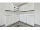 Garage featuring white cabinets providing ample storage for your convenience at 1460 Kensington Woods Dr, Lutz, FL 33549