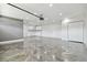 Spacious garage featuring epoxy floors, ample storage, and recessed lighting at 1460 Kensington Woods Dr, Lutz, FL 33549