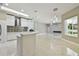 Modern kitchen with waterfall island, stone backsplash, pendant lighting, and marble flooring at 1460 Kensington Woods Dr, Lutz, FL 33549