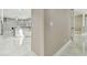 View of the home's entryway, hallway, and a partial view of the adjacent kitchen at 1460 Kensington Woods Dr, Lutz, FL 33549